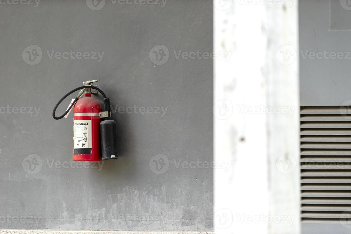 A fire extinguisher is mounted on the wall photo