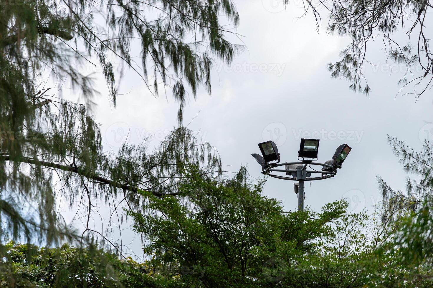 A street light with four lights on top of it photo