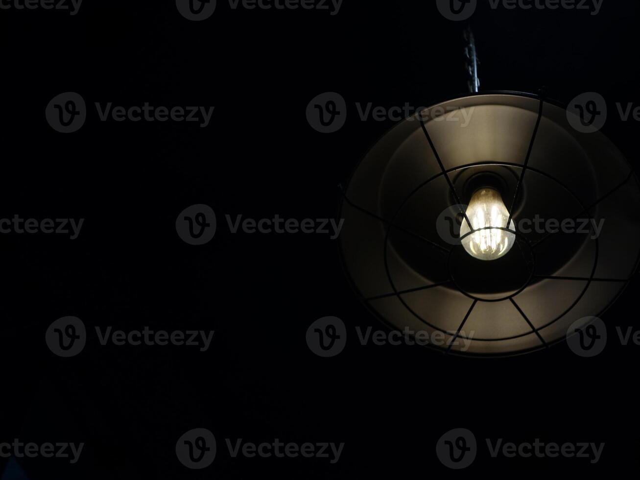 A light bulb hanging from a ceiling photo
