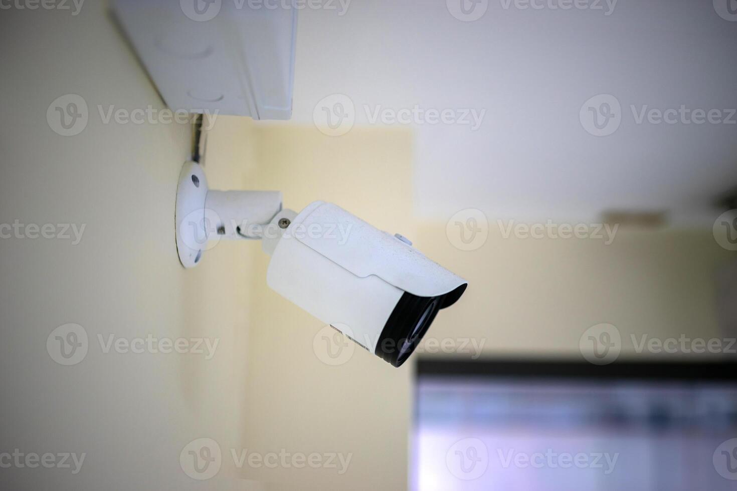 A security camera mounted on a wall photo