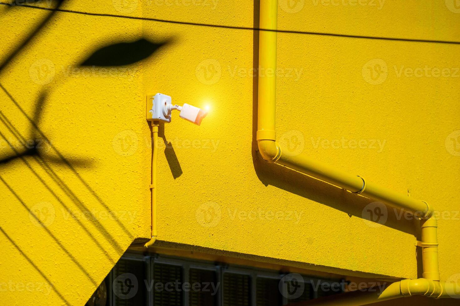 A yellow building with a light on it photo