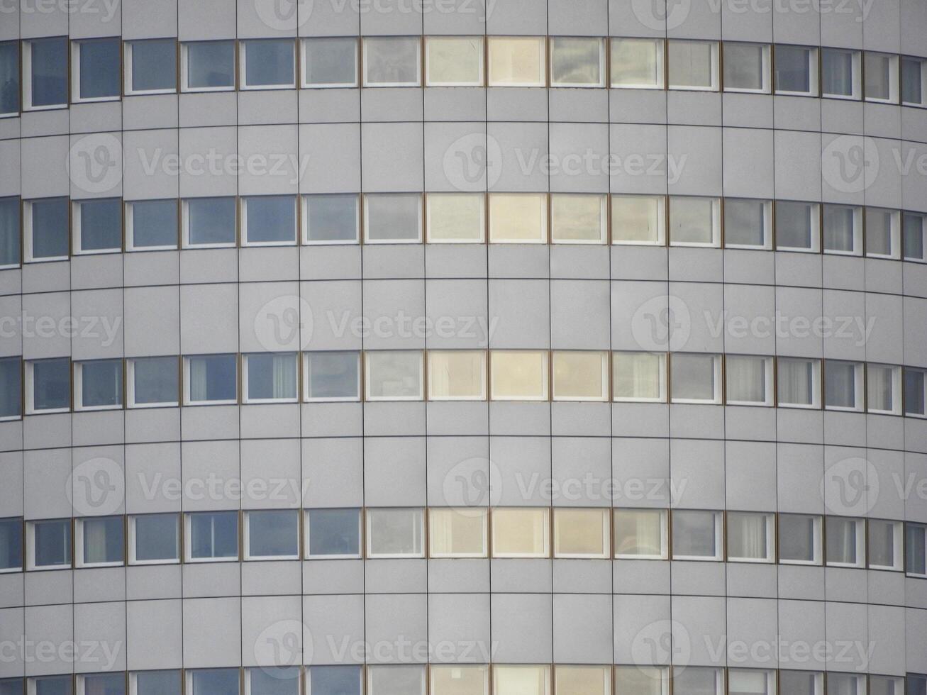 A building with many windows and a clock on it photo