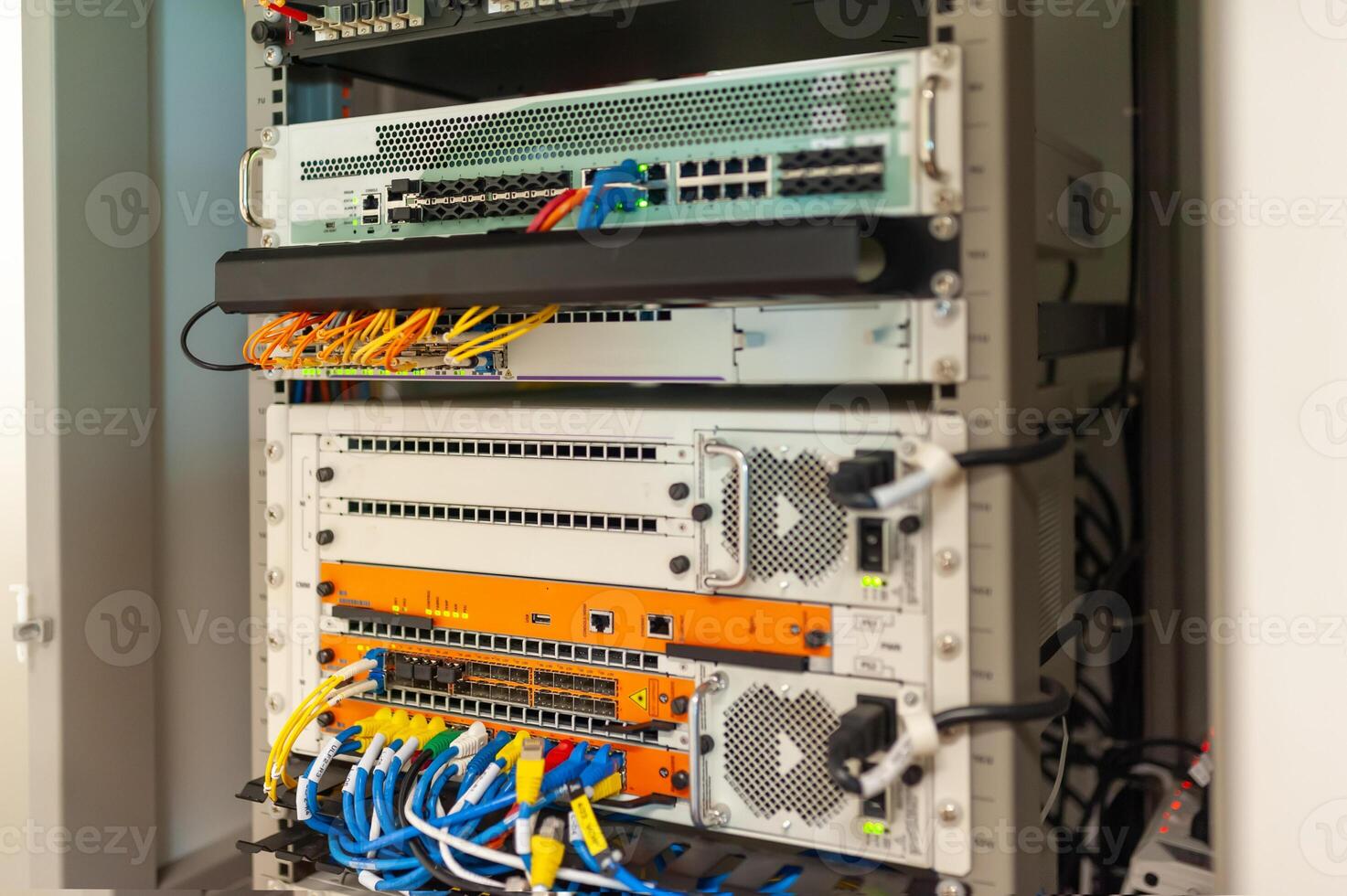A rack of servers with various cables and wires photo