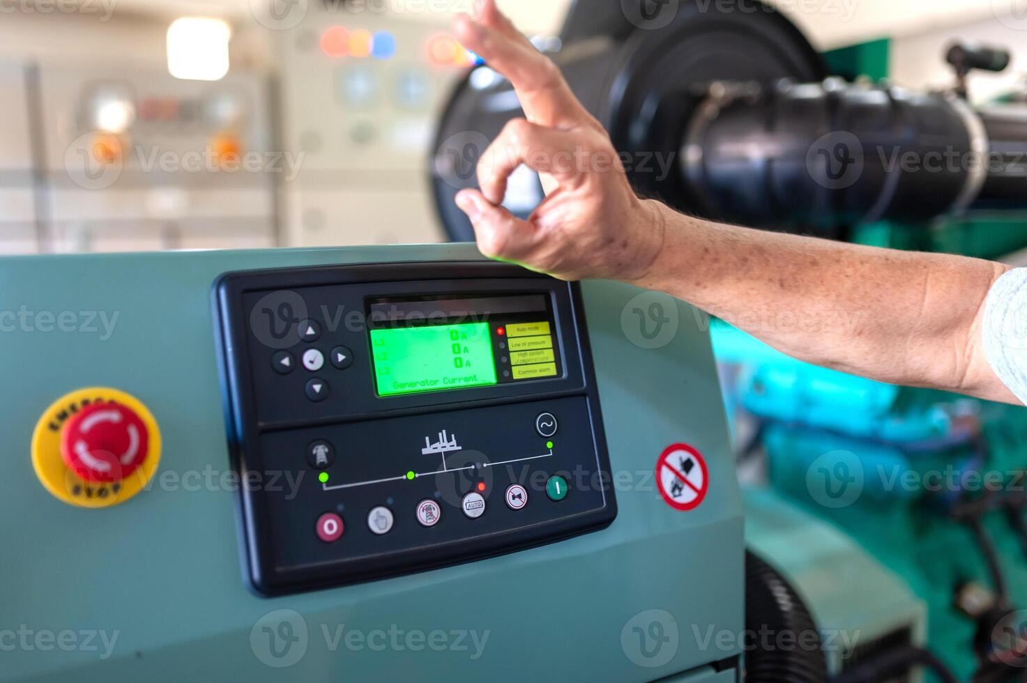 A man pointing at a machine in a factory photo