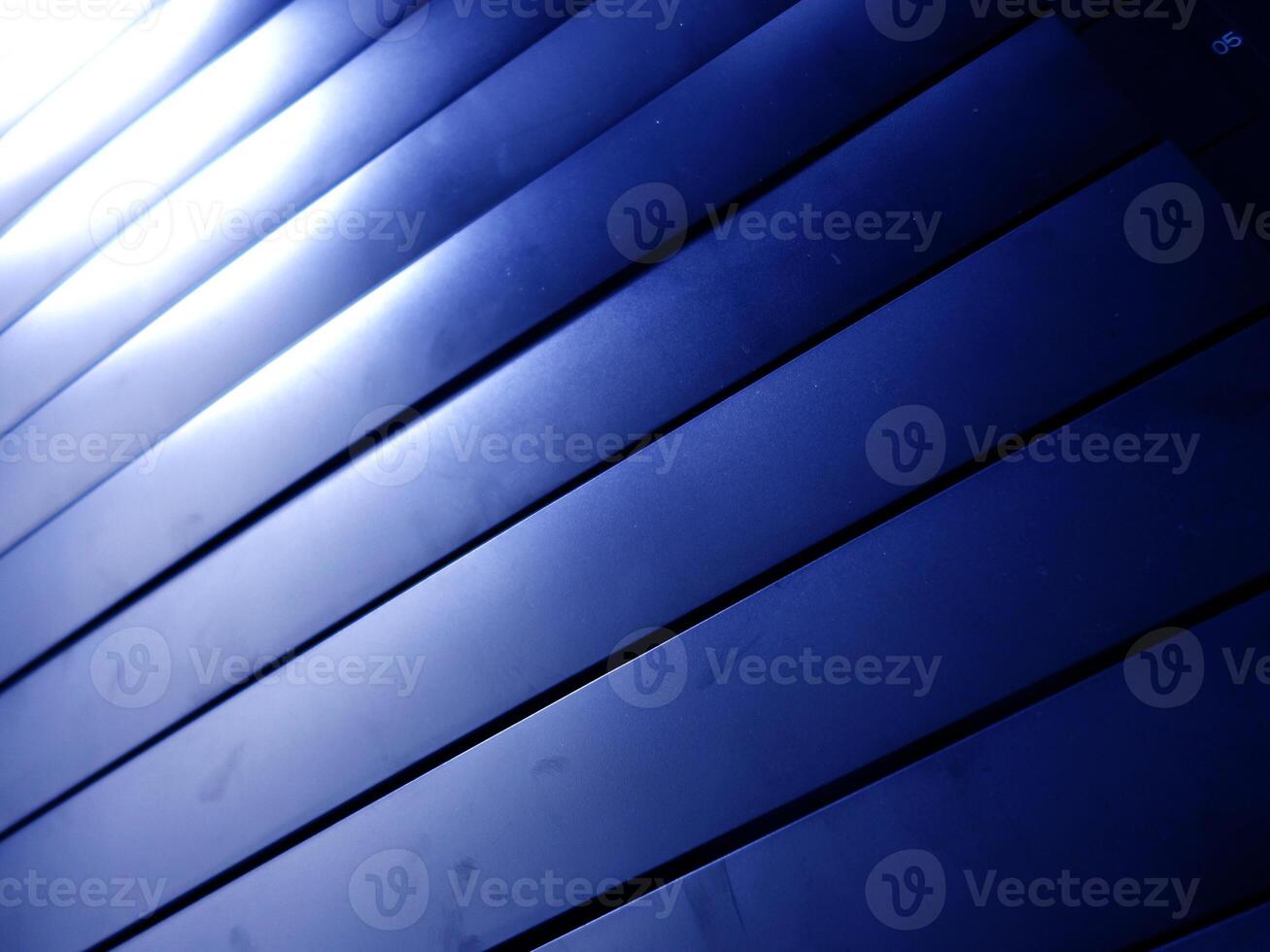 A blue wall with a blue light shining through it photo