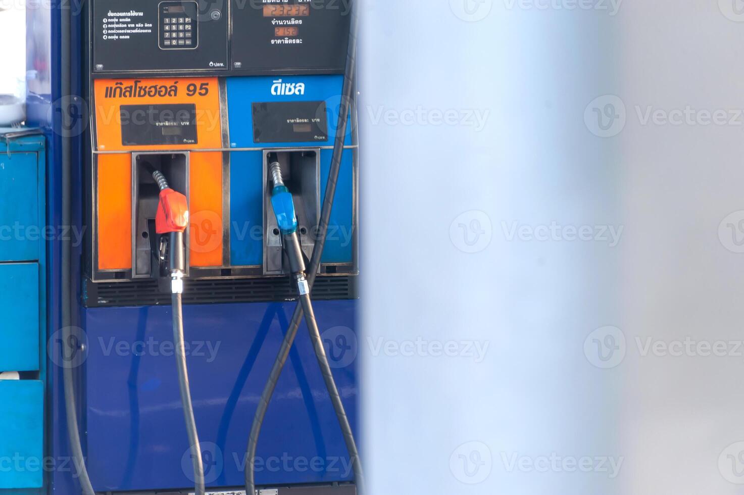 A gas pump with two orange and blue pumps photo