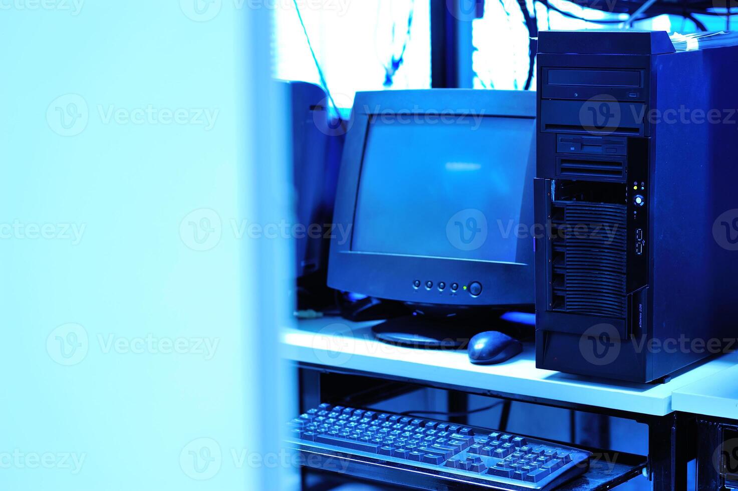 A computer desk with a computer, keyboard, mouse, and monitor photo