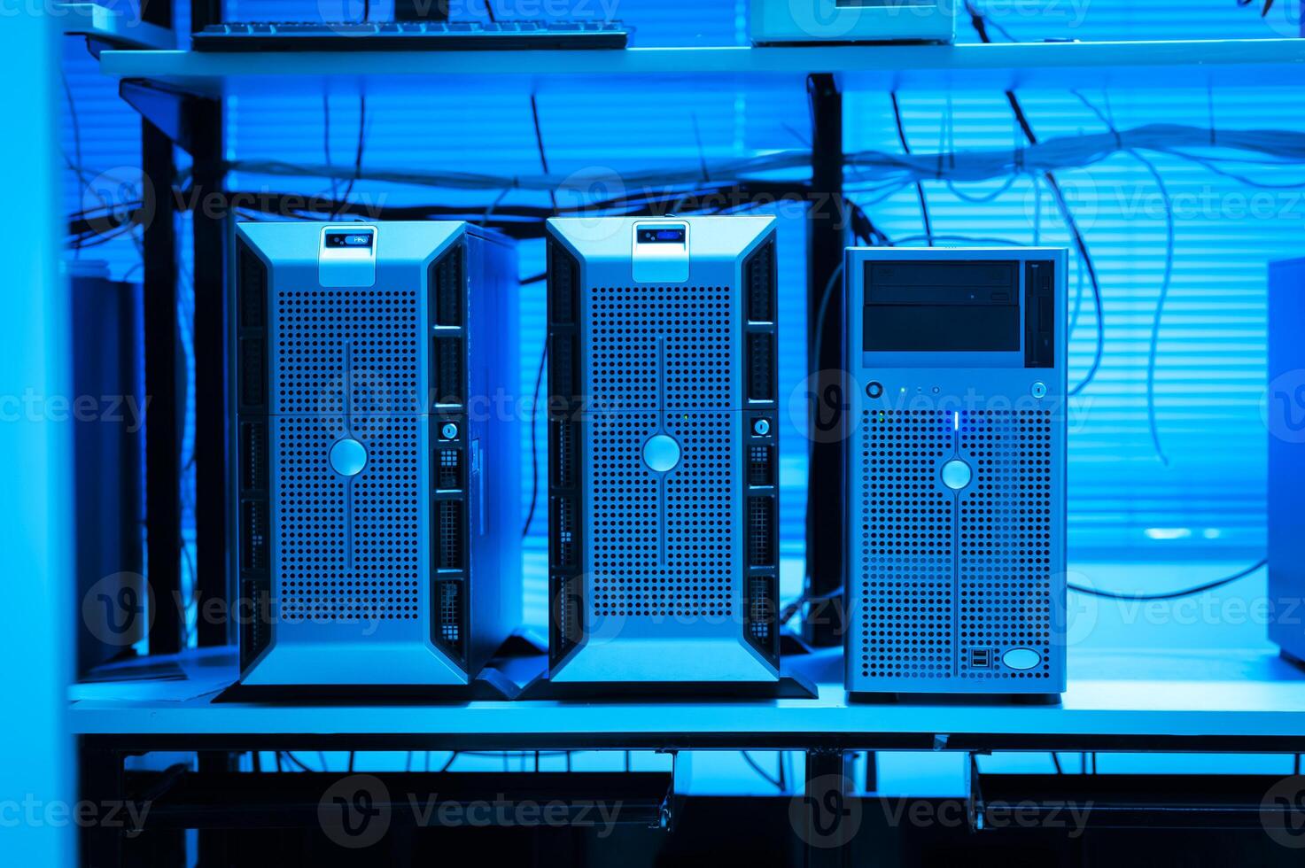 A row of computers in a room with blue lighting photo