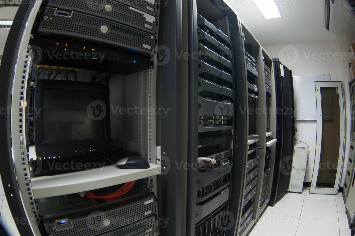 A room with a lot of servers and a monitor photo