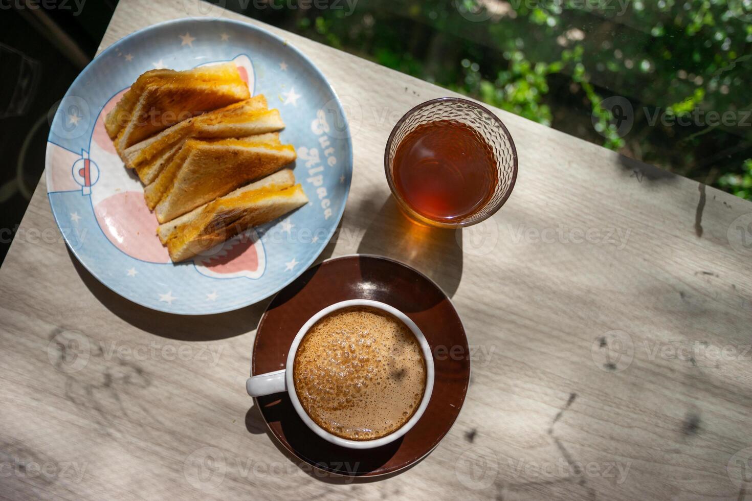 A plate of food and a cup of coffee on a table photo