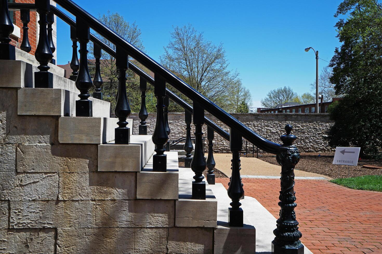 Exterior design and architecture of outdoor staircase with 'ENTRANCE' directional sign photo