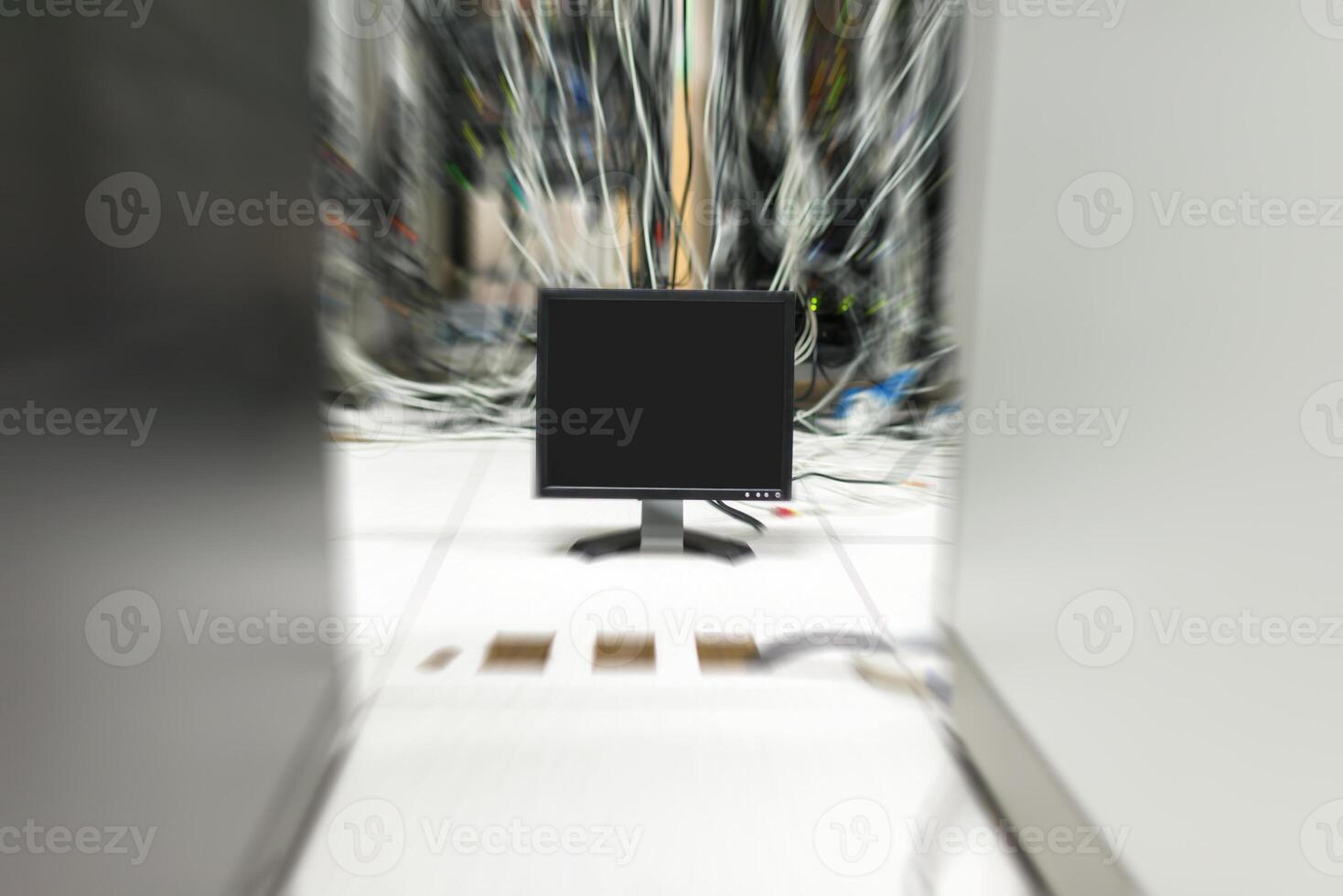 A computer monitor in a room with wires photo