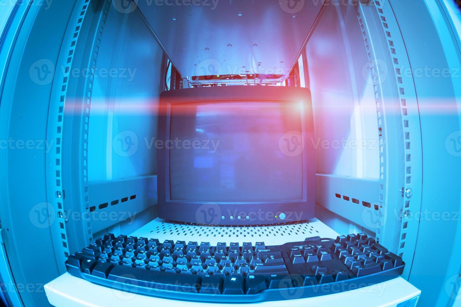 A computer keyboard and monitor in a computer server room photo