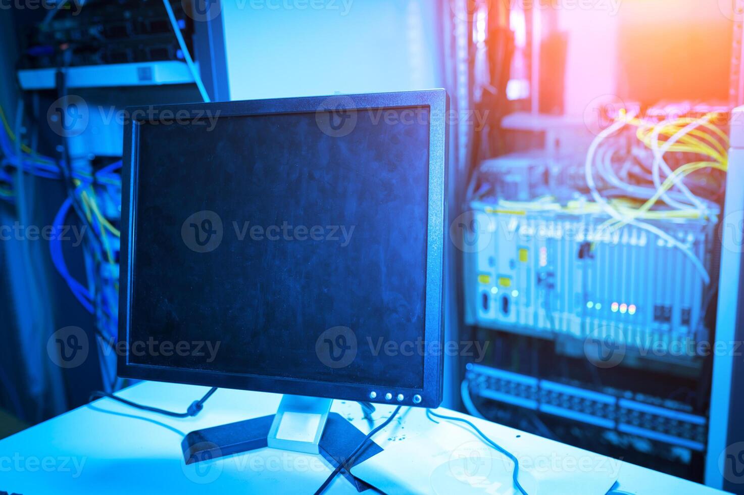 A computer monitor is sitting on top of a desk photo