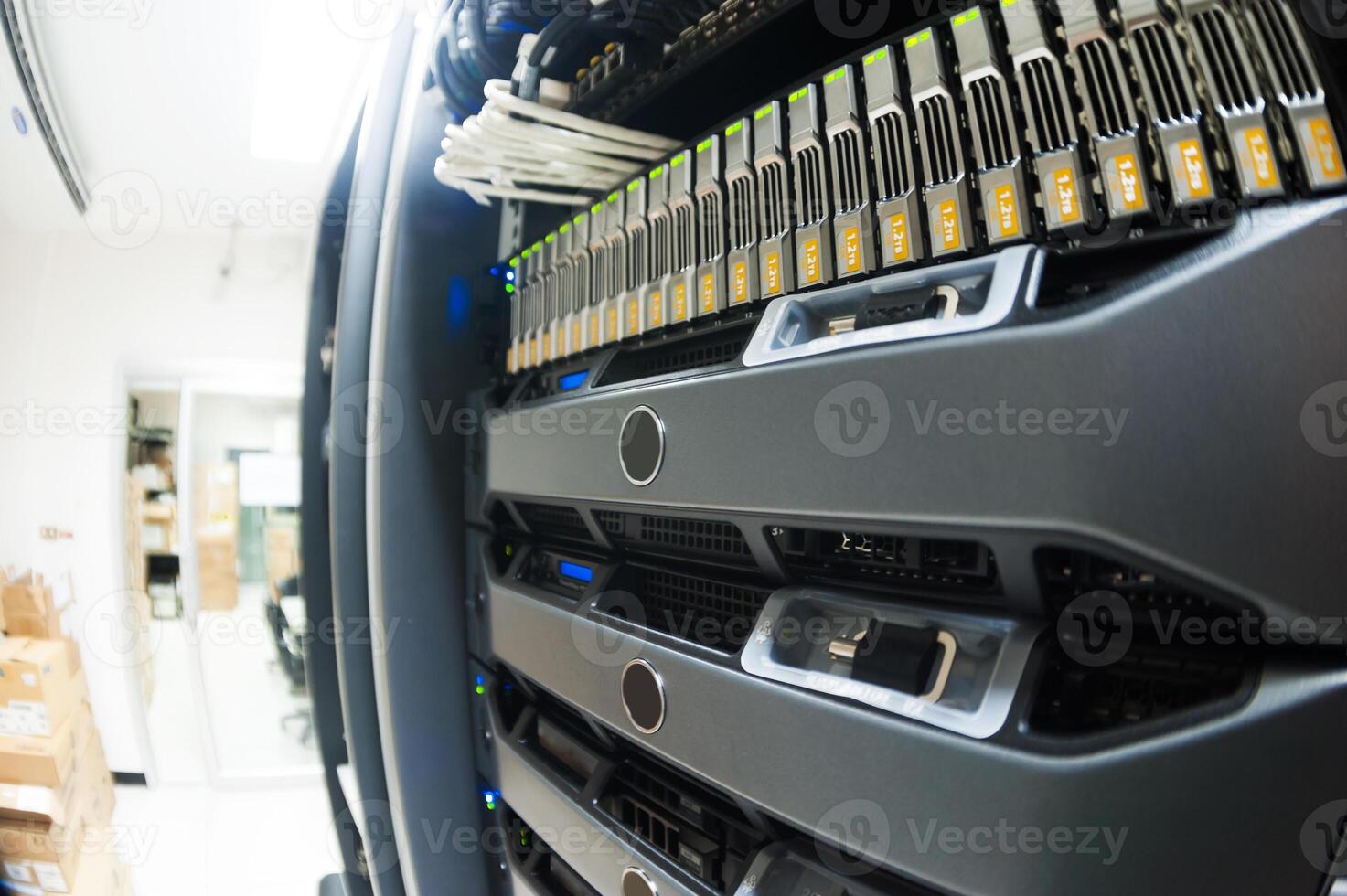 A close up of a server rack with many different types of cables photo