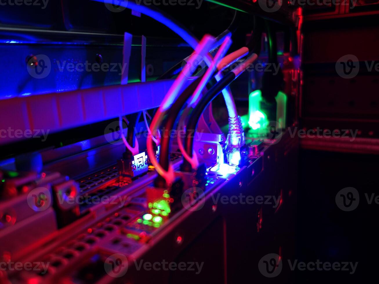 A computer with wires and a red light photo