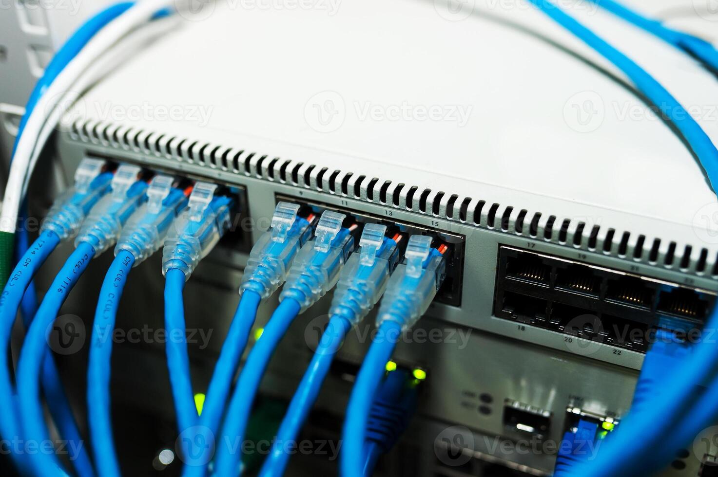 A close up of a network switch with blue cables photo