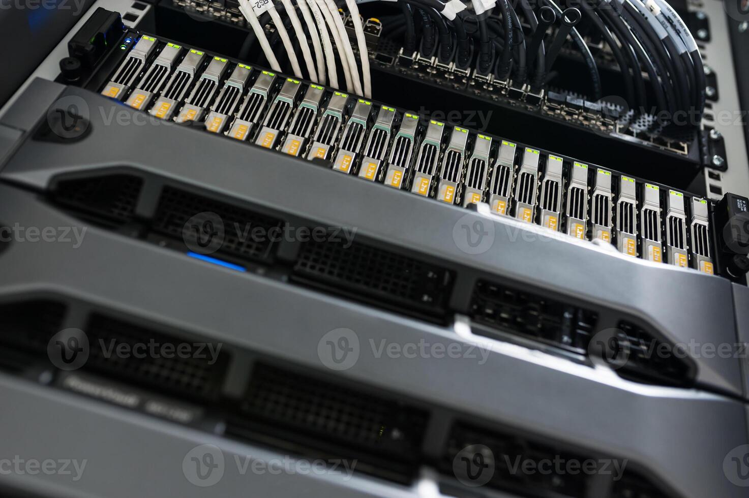 A close up of a server rack with multiple cables photo
