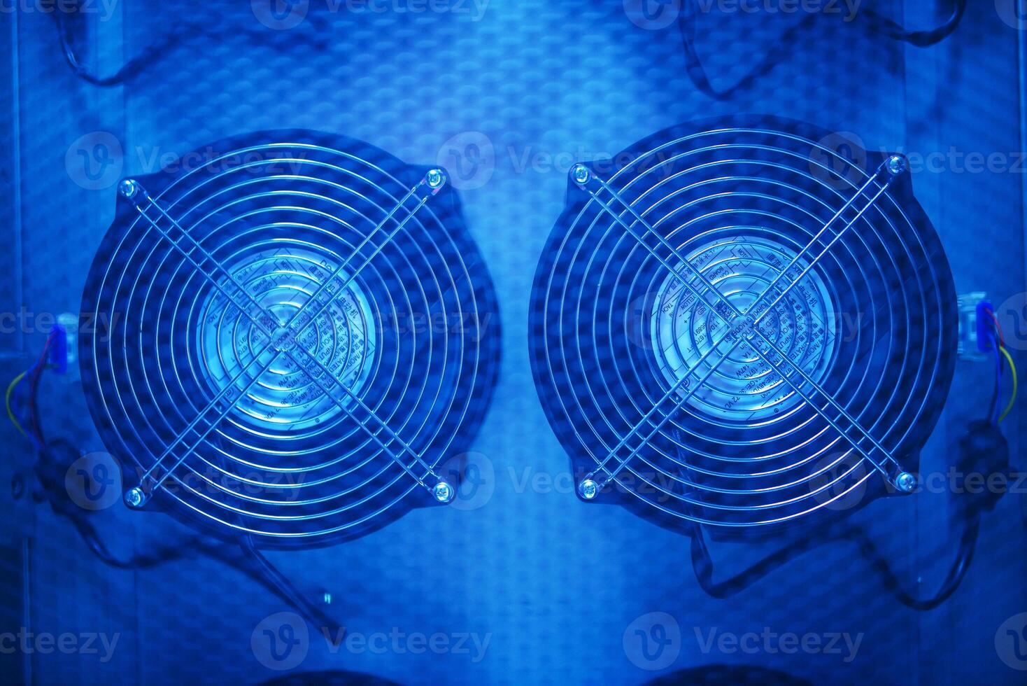 Two fans are shown in a blue light photo