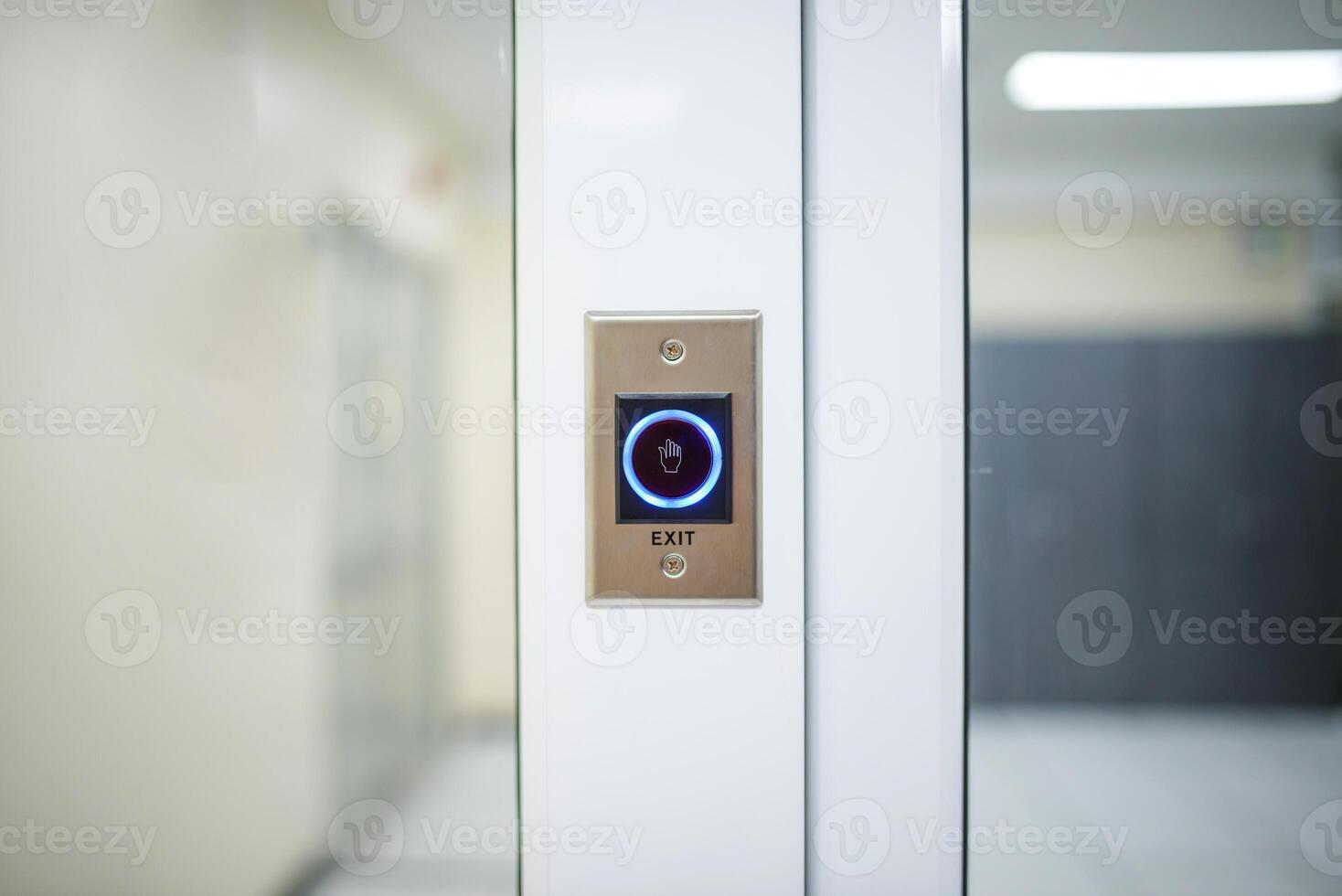 A door with a button on it in a hallway photo