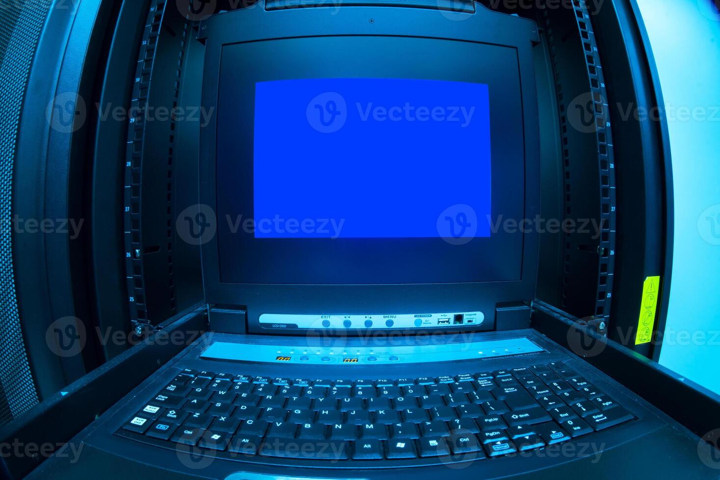 A computer with a blue screen sitting on a table photo