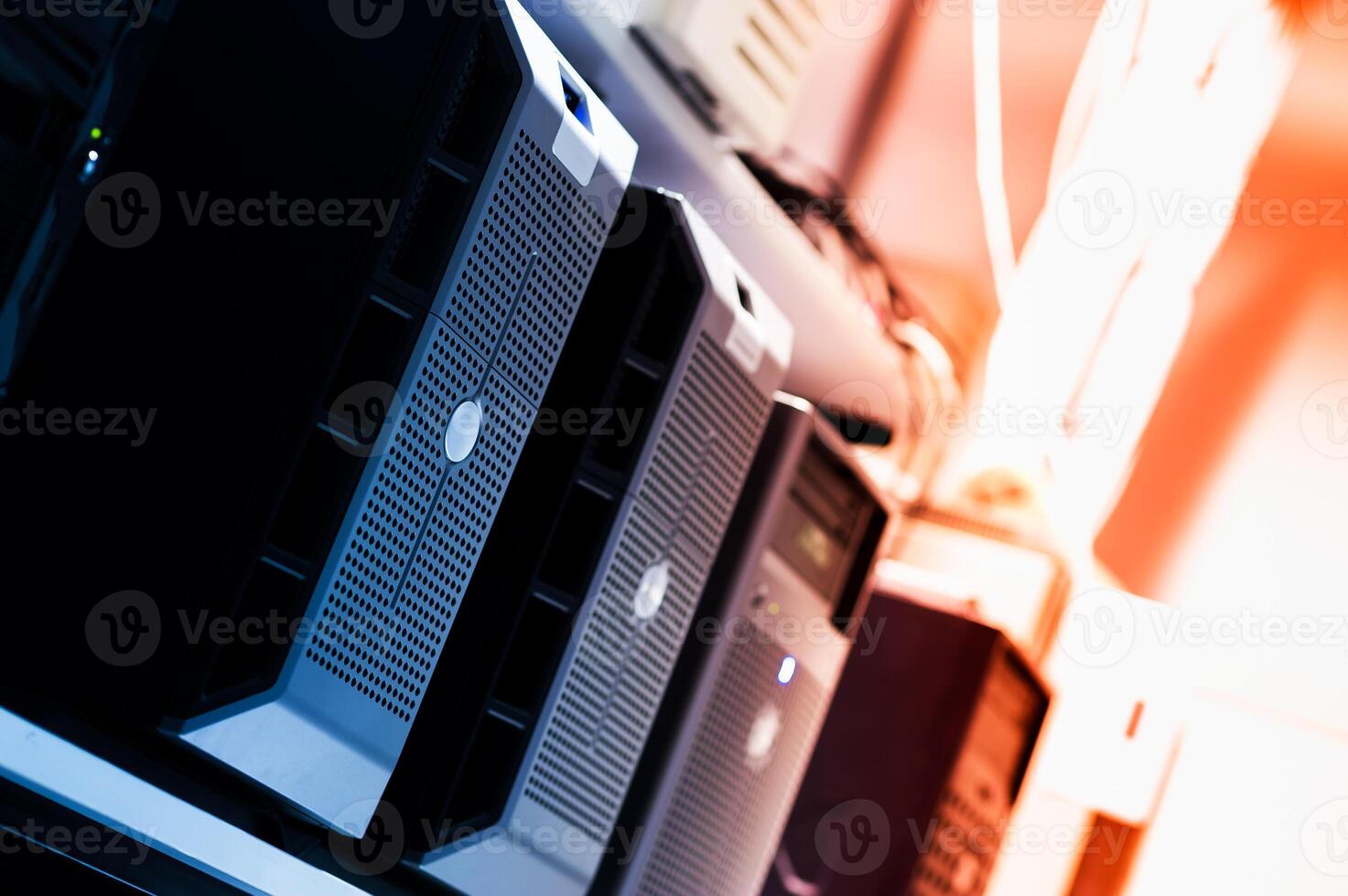 A row of computers in a room with a red light photo