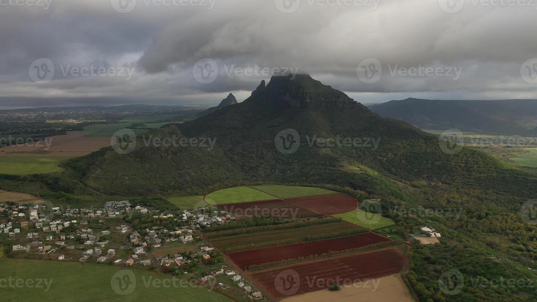 Aerial photography of the beautiful green countryside of Mauritius with fields and mountain views photo