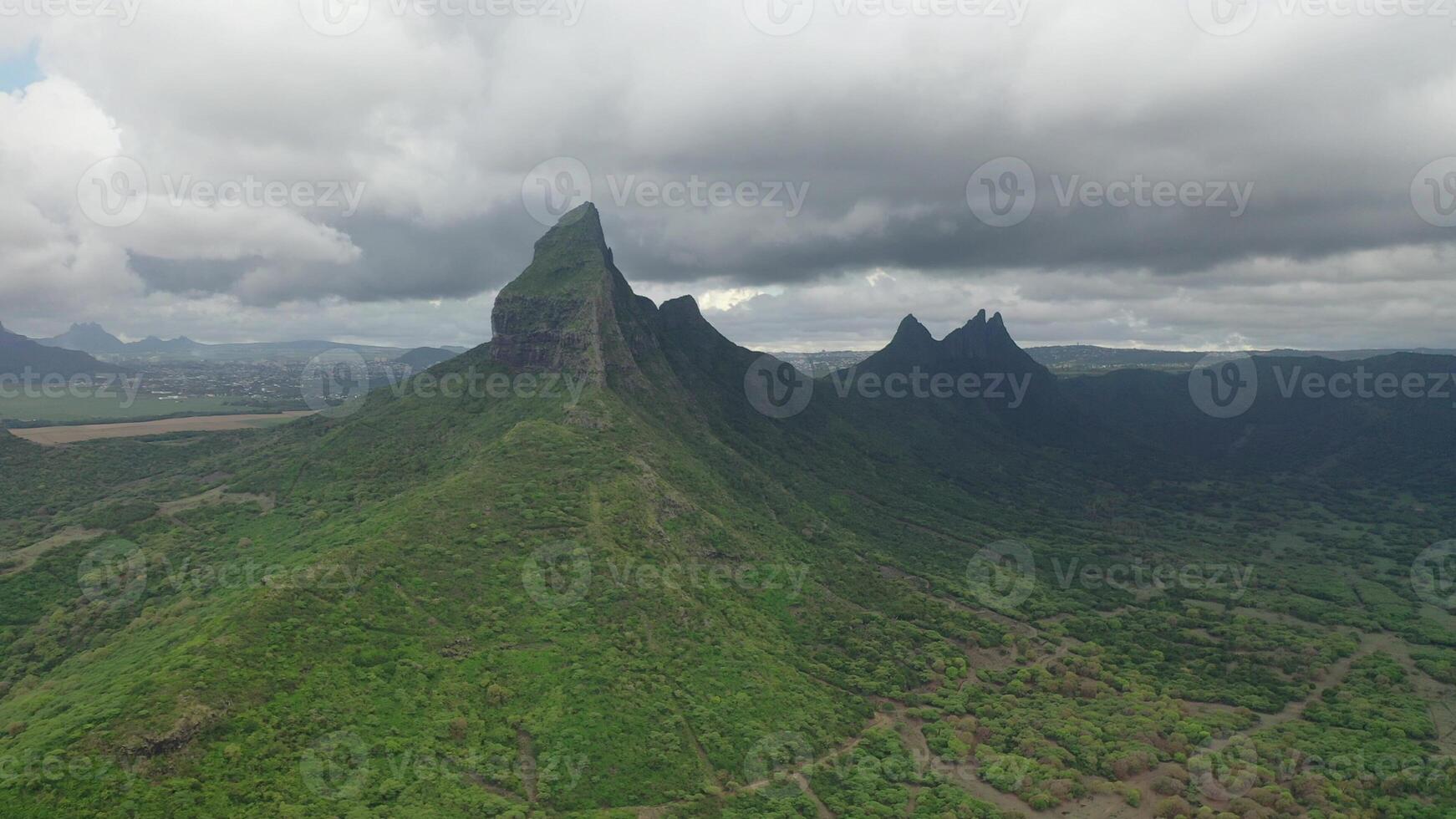 shooting from top to bottom the peaks of mountains and jungles of Mauritius, the sky in clouds photo