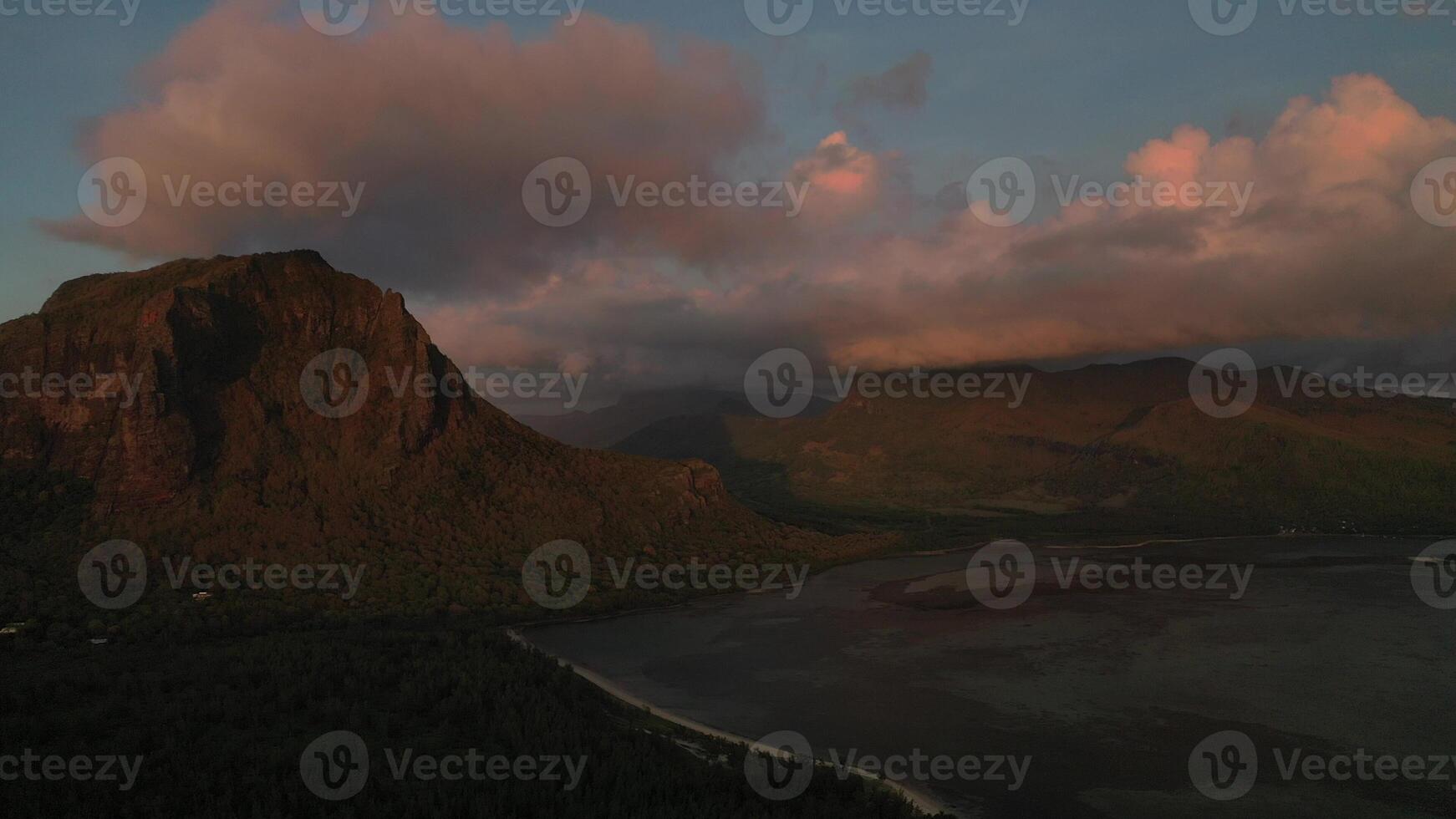 Amazing sunset from the height of mount Le Morne Brabant and the waves of the Indian ocean in Mauritius .Underwater waterfall near mount Le Morne in the Indian ocean. photo