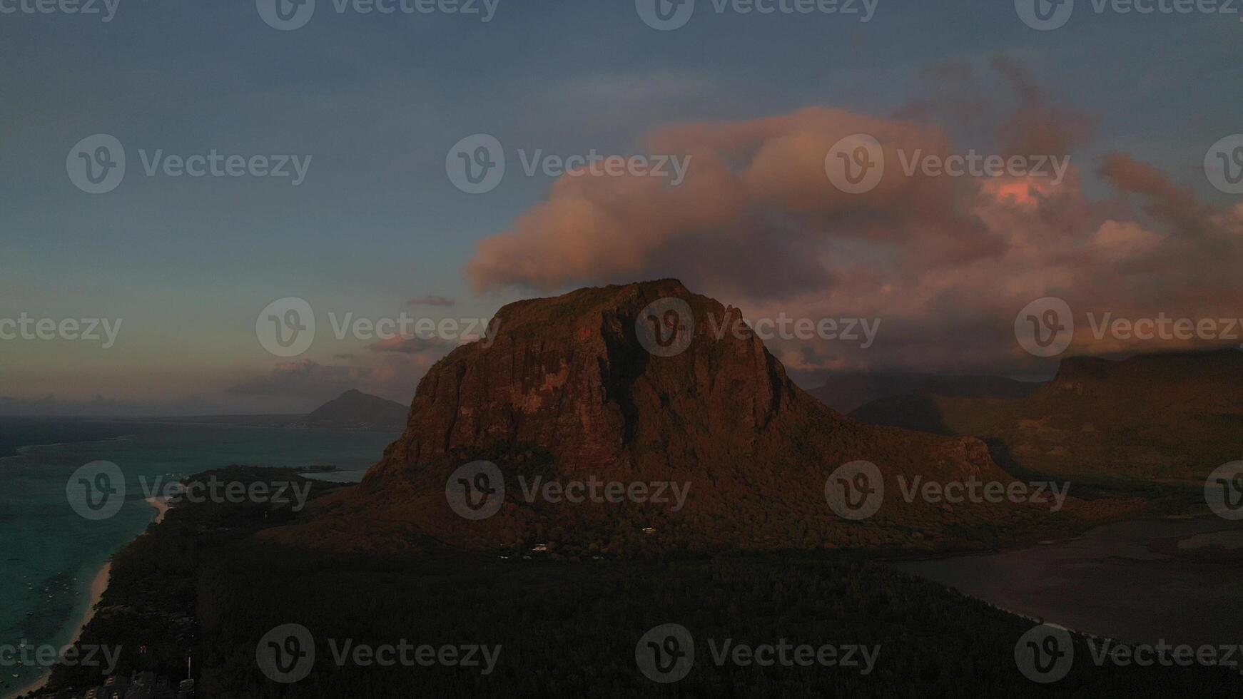 Amazing sunset from the height of mount Le Morne Brabant and the waves of the Indian ocean in Mauritius .Underwater waterfall near mount Le Morne in the Indian ocean. photo
