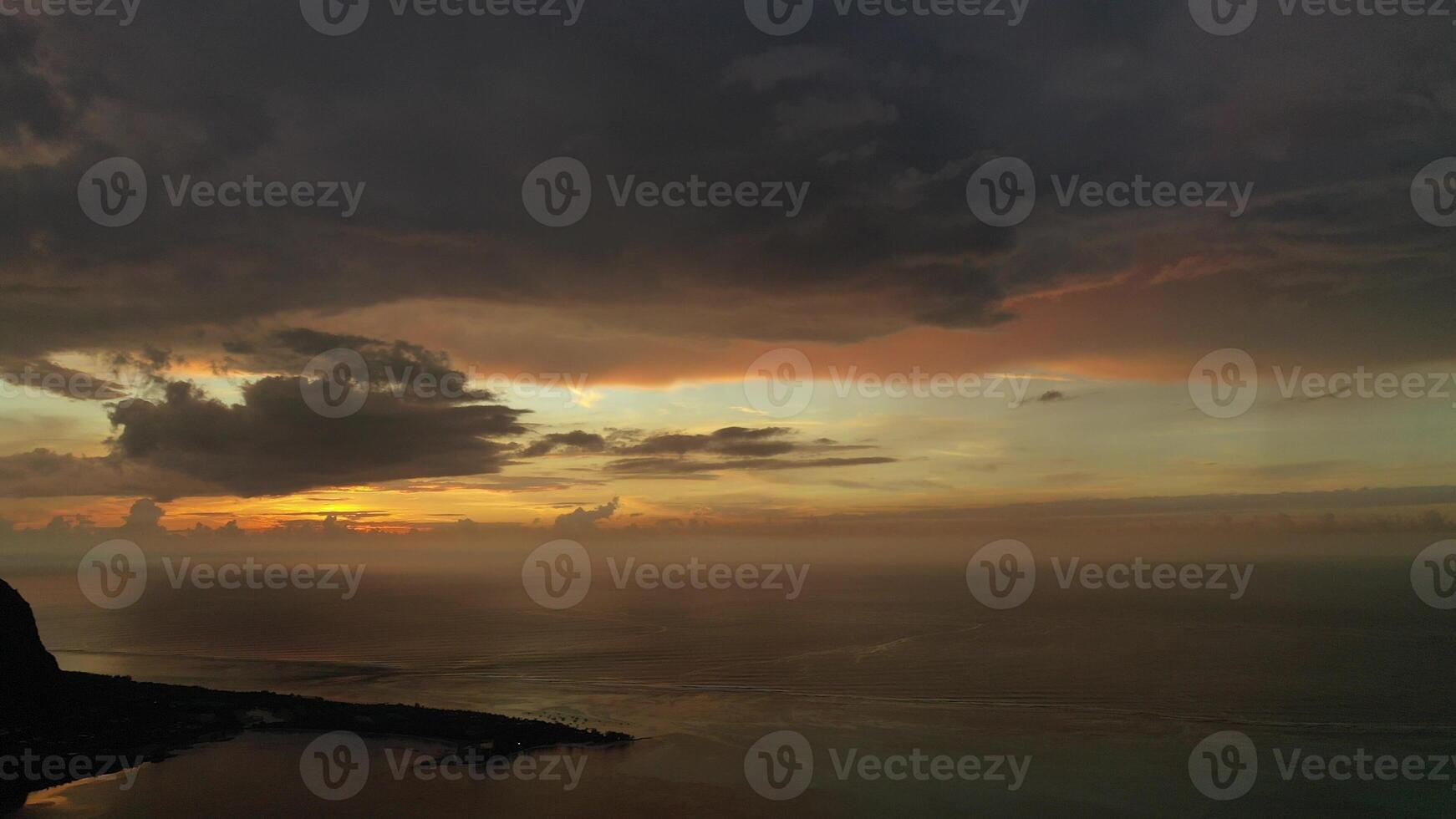 Amazing sunset from the height of mount Le Morne Brabant and the waves of the Indian ocean in Mauritius .Underwater waterfall near mount Le Morne in the Indian ocean. photo