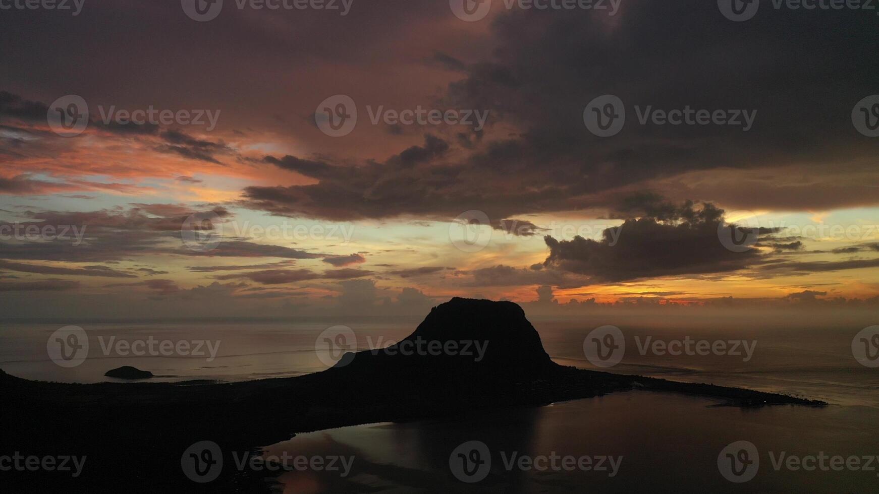 Amazing sunset from the height of mount Le Morne Brabant and the waves of the Indian ocean in Mauritius .Underwater waterfall near mount Le Morne in the Indian ocean. photo