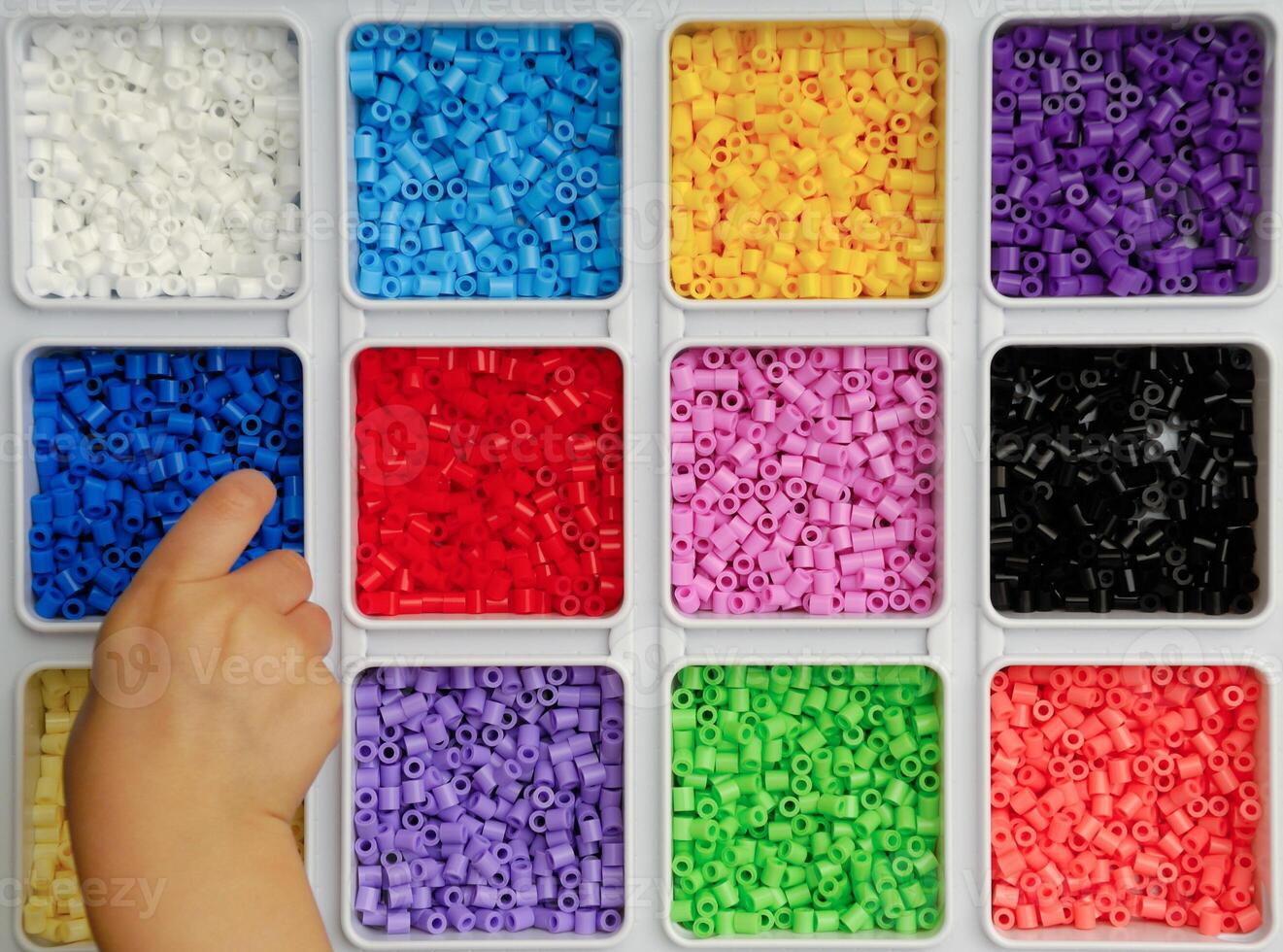 Child playing with toy pearls photo