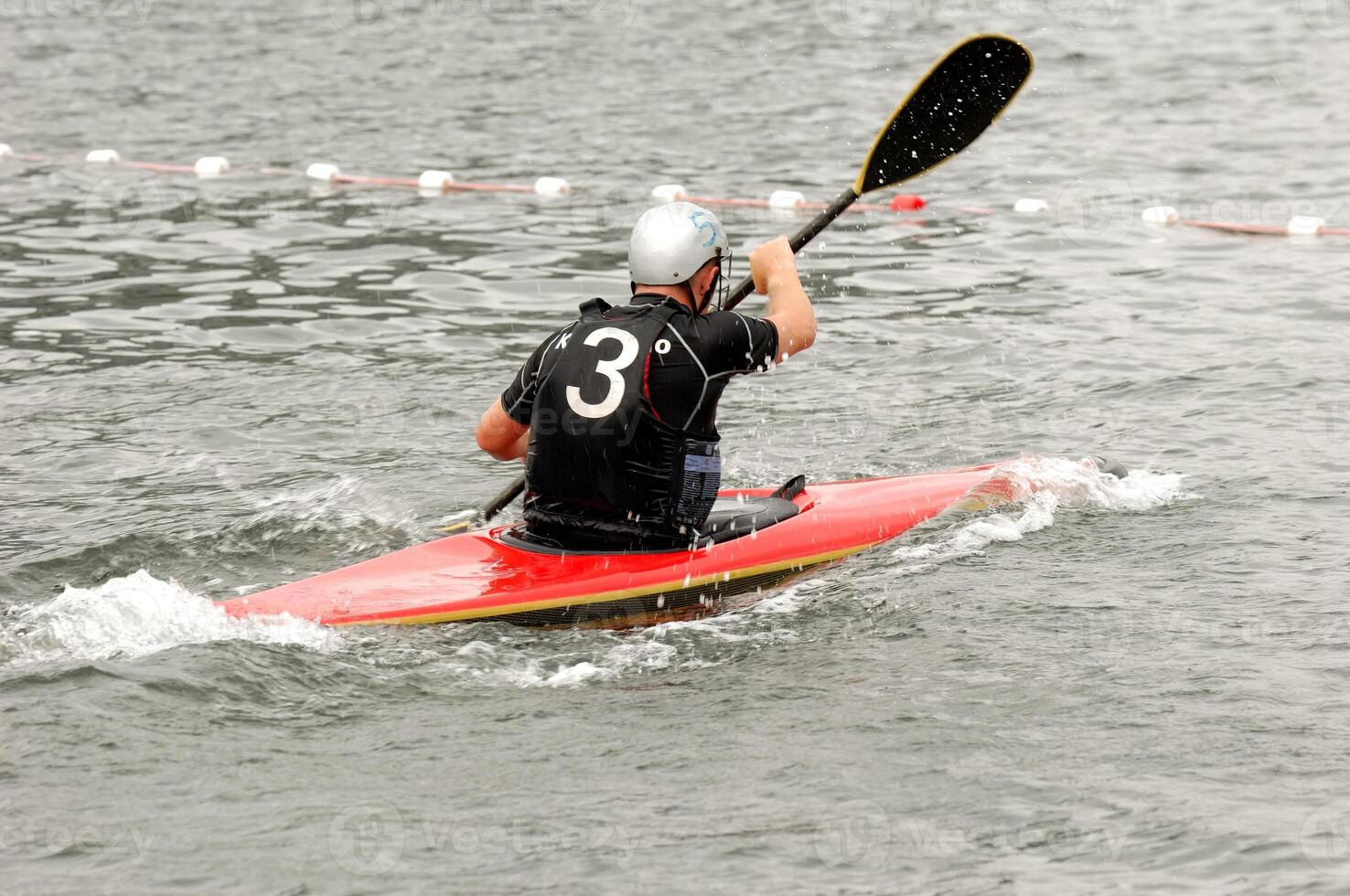 Man paddling in his kayak photo
