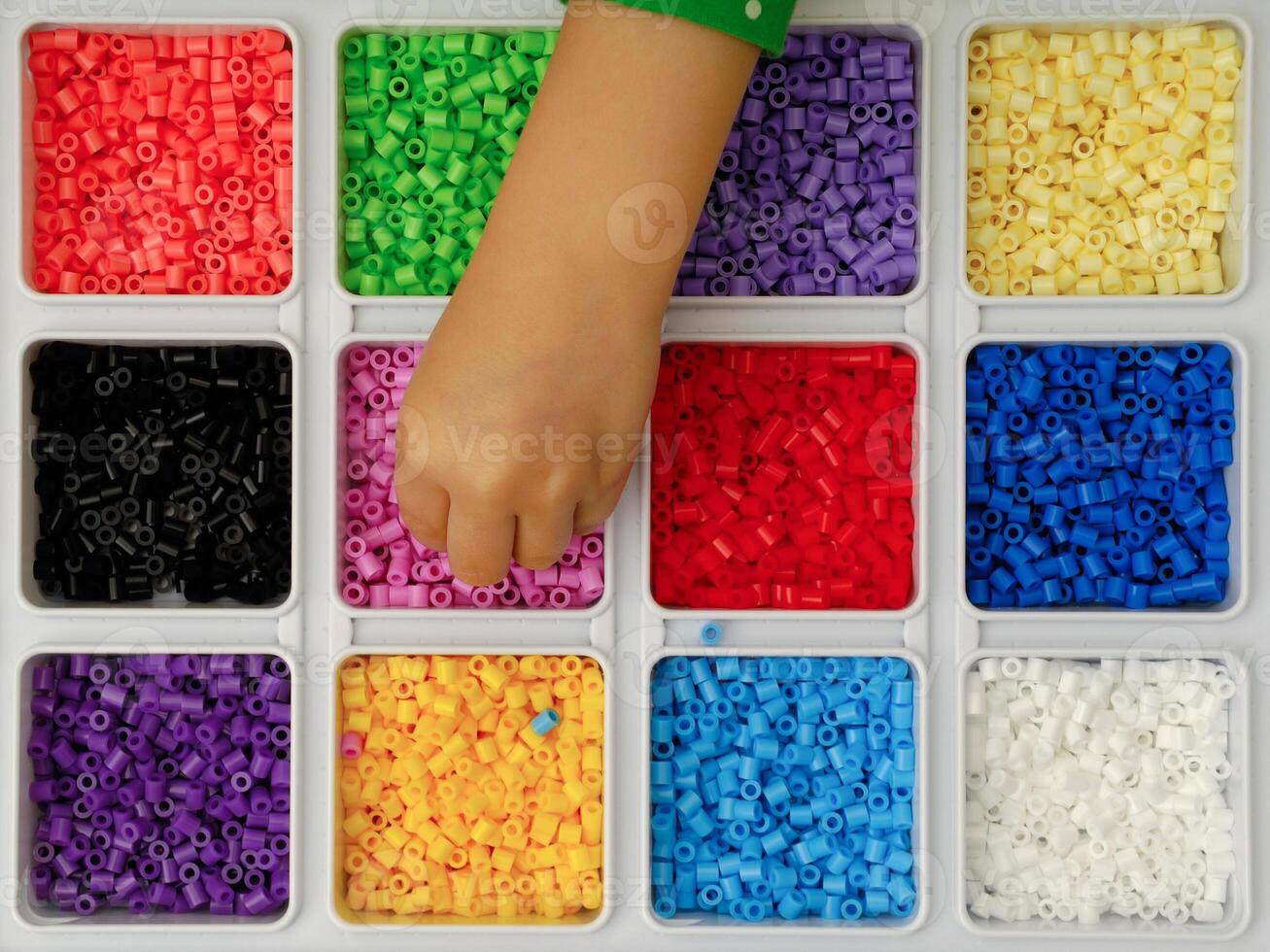 Child playing with toy pearls photo