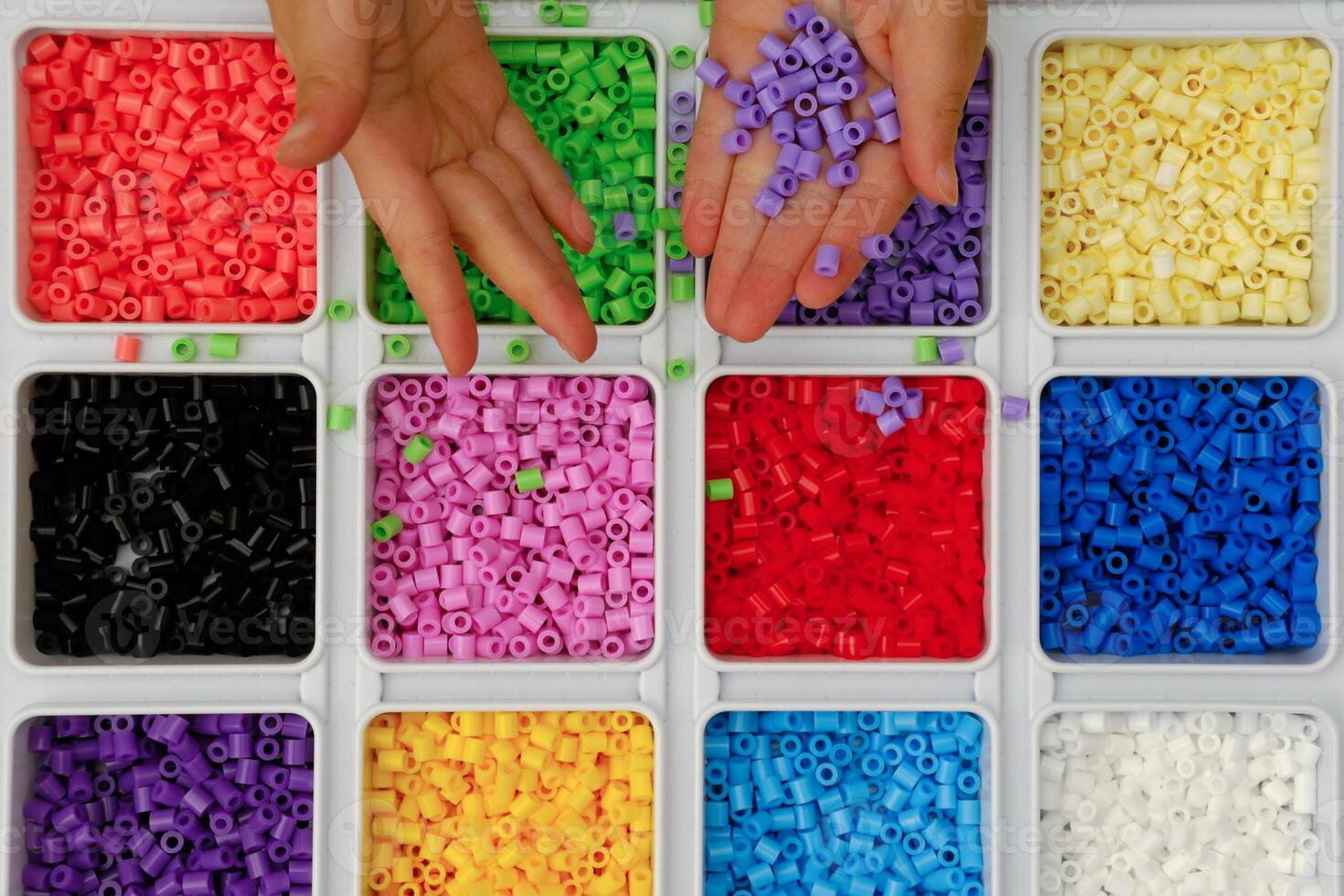 Child playing with toy pearls photo