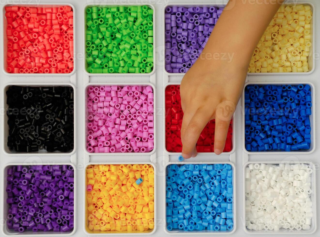 Child playing with toy pearls photo