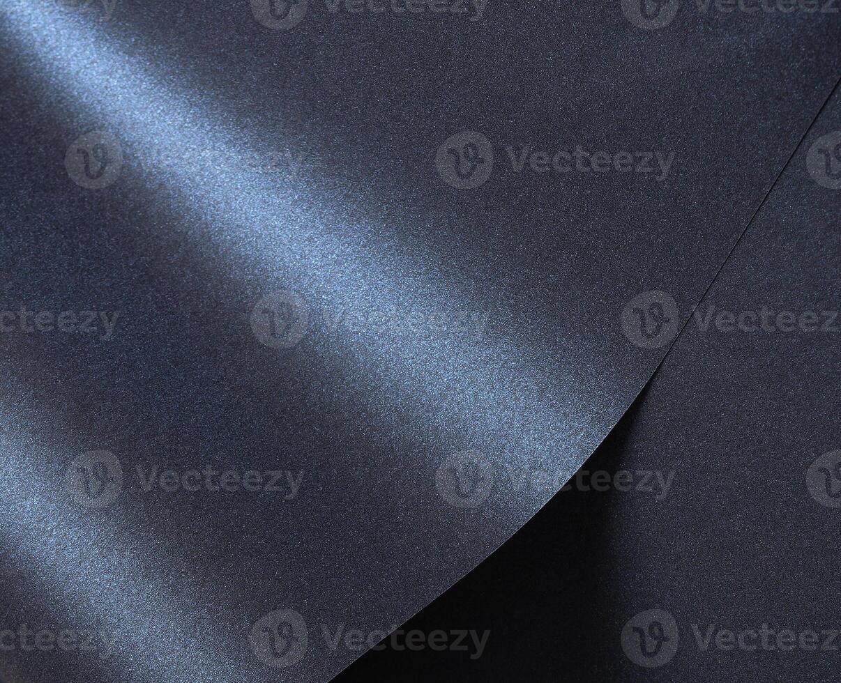 Luxurious designer paper background in deep navy blue with a glossy, satin finish and rich gradient. photo