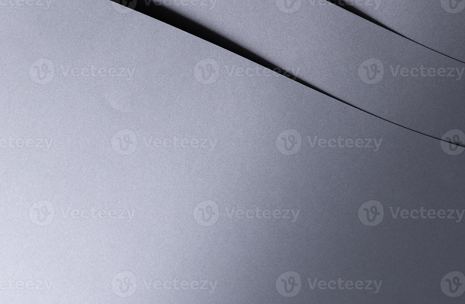 Elegant designer paper background with a smooth, glossy metallic gradient in rich gray tones. This photo