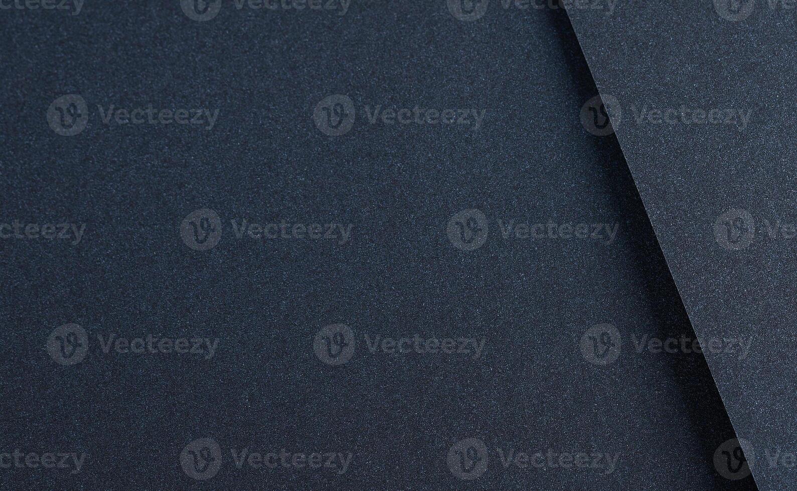 Luxurious designer paper background in deep navy blue with a smooth, shadowed texture. This dark, photo