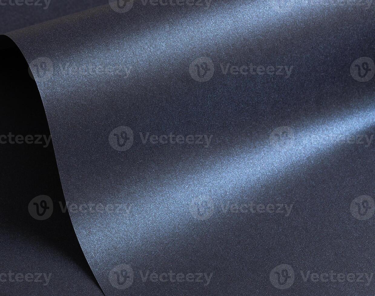 Glossy designer paper background with a deep navy blue gradient and a cool, metallic satin finish. photo