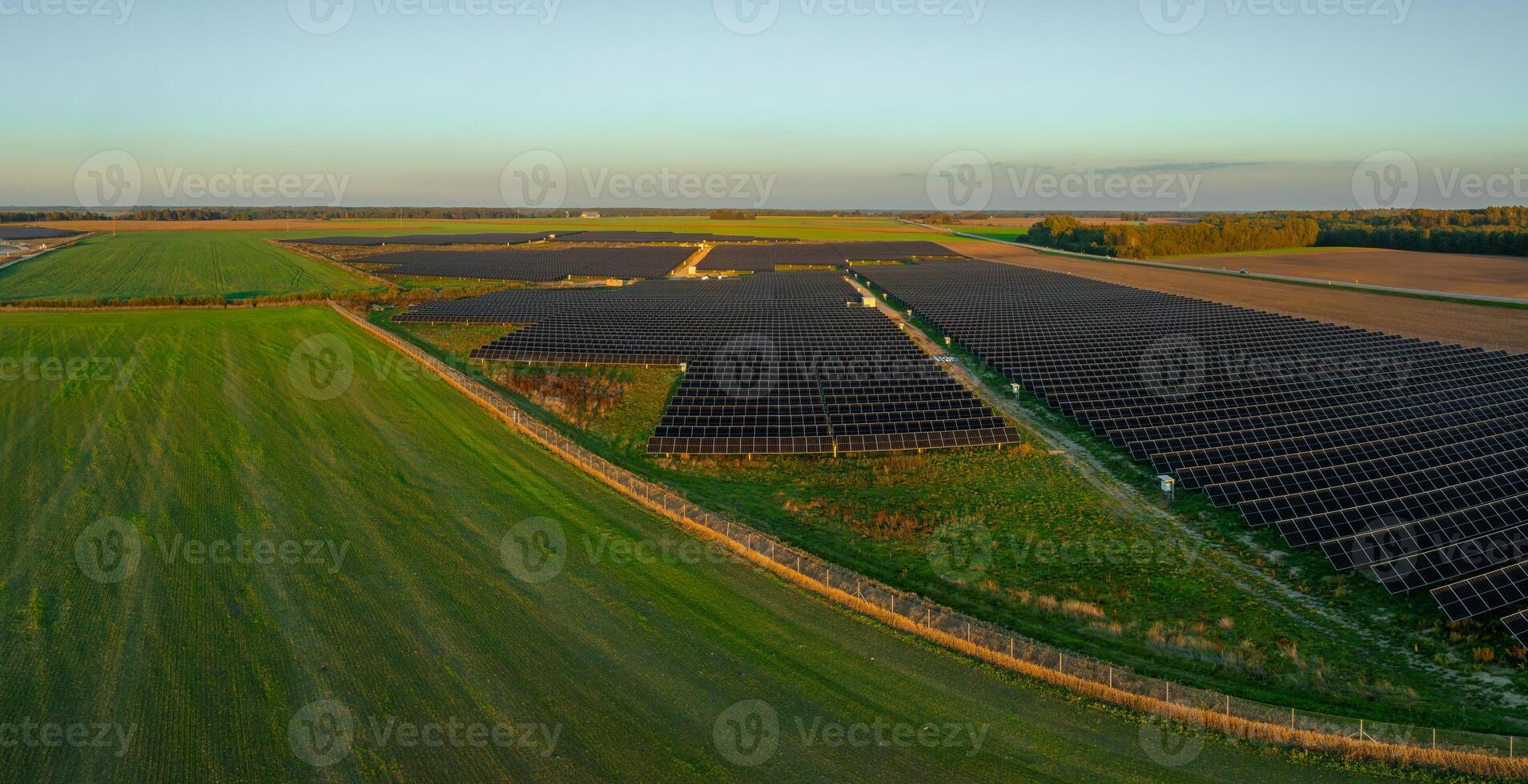 Aerial View of Expansive Solar Panel Field in Lithuania photo