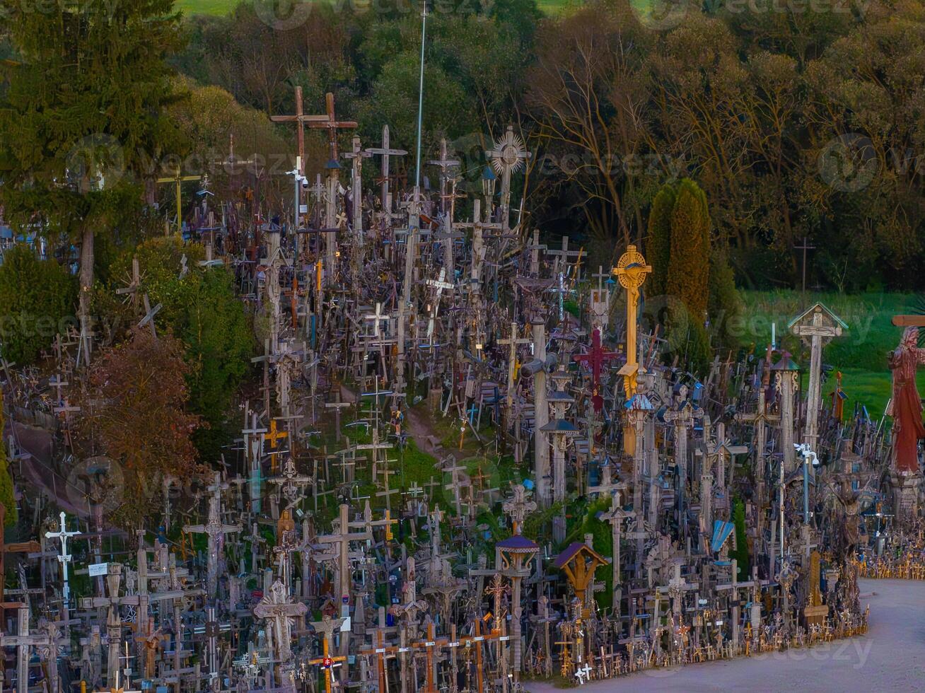 Hill of Crosses in Lithuania with Dense Forest Background photo