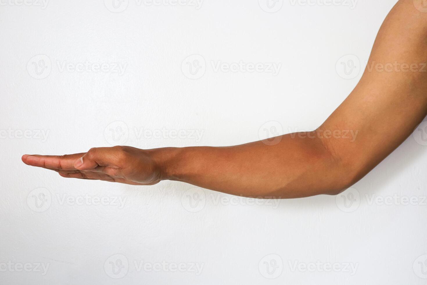 A man's arm is pointing out to the side photo