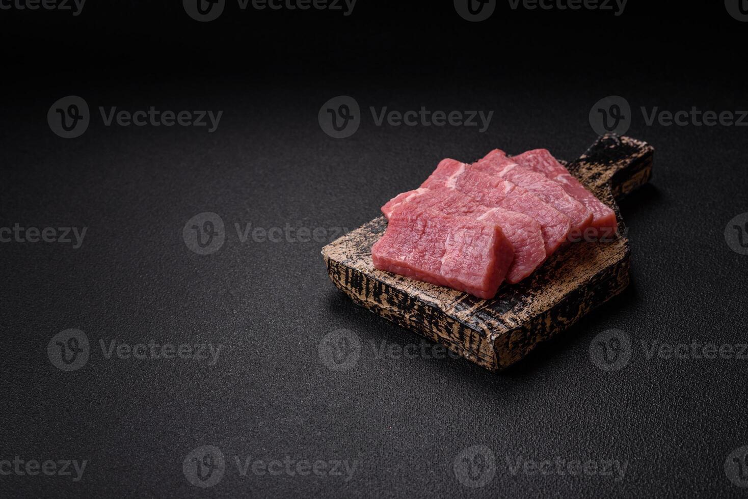 Juicy beef cut into slices with salt, spices and herbs photo