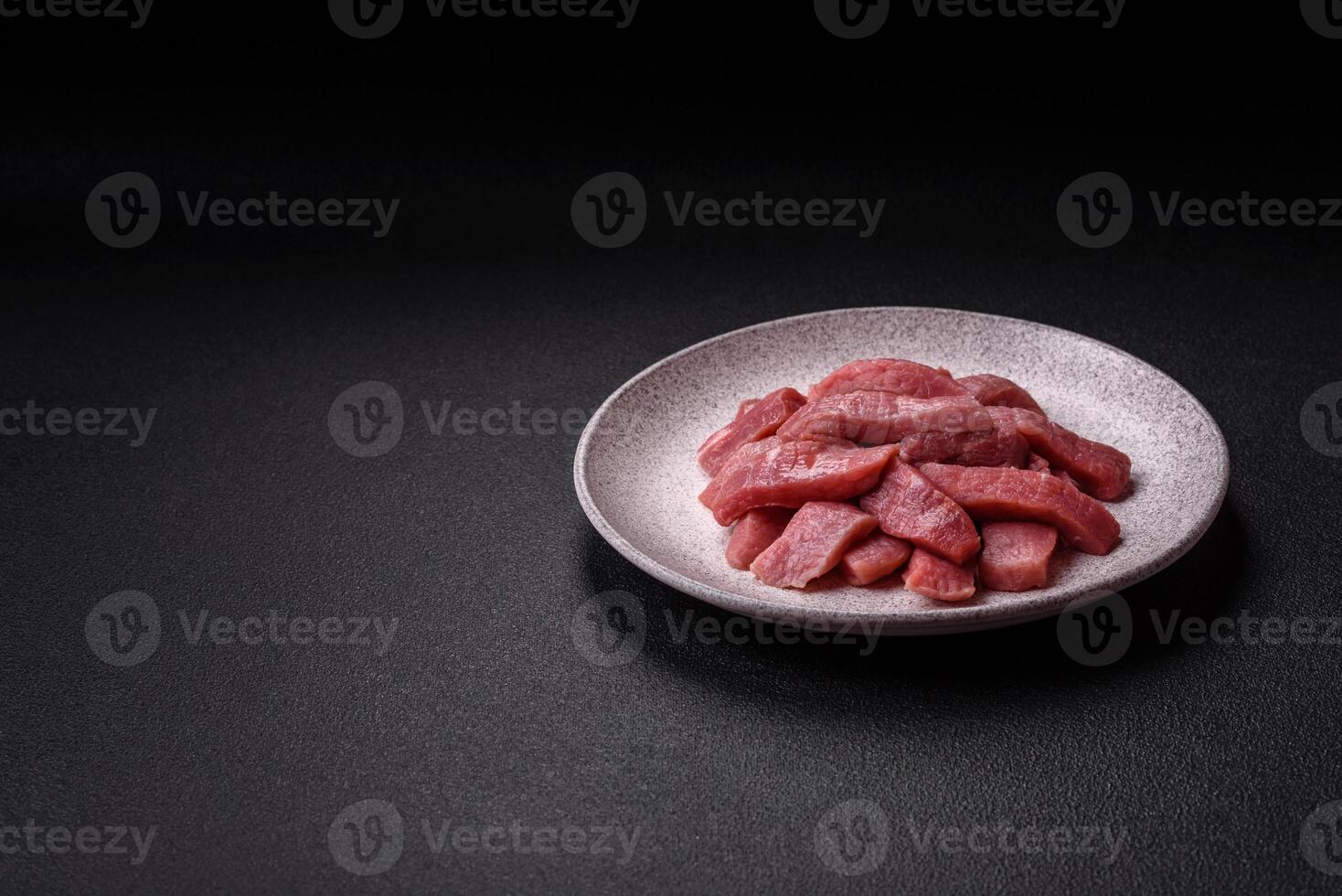 Juicy beef cut into slices with salt, spices and herbs photo