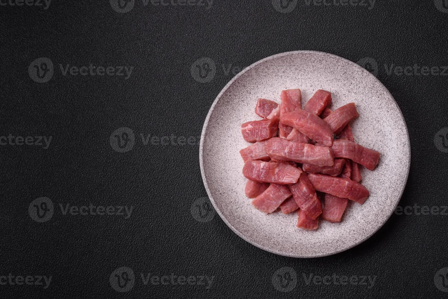 Juicy beef cut into slices with salt, spices and herbs photo