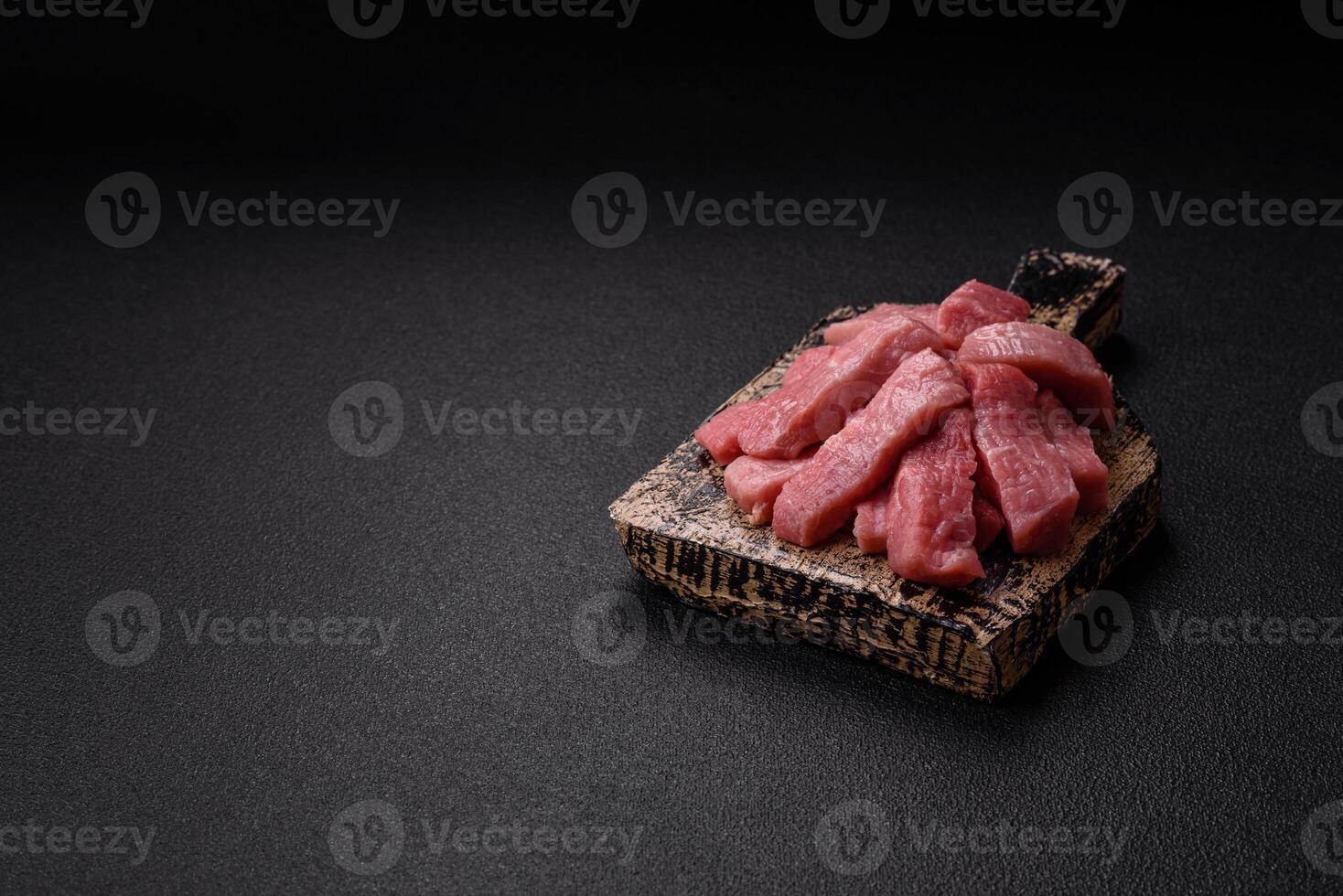 Juicy beef cut into slices with salt, spices and herbs photo