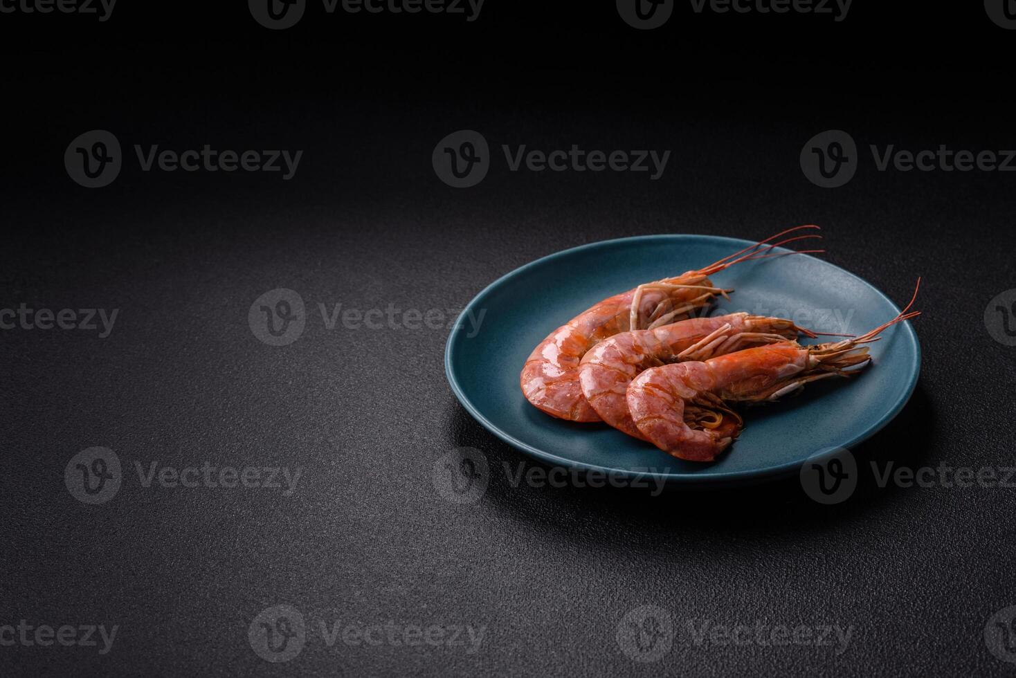 Boiled tiger prawns with salt, spices, herbs and vegetables photo