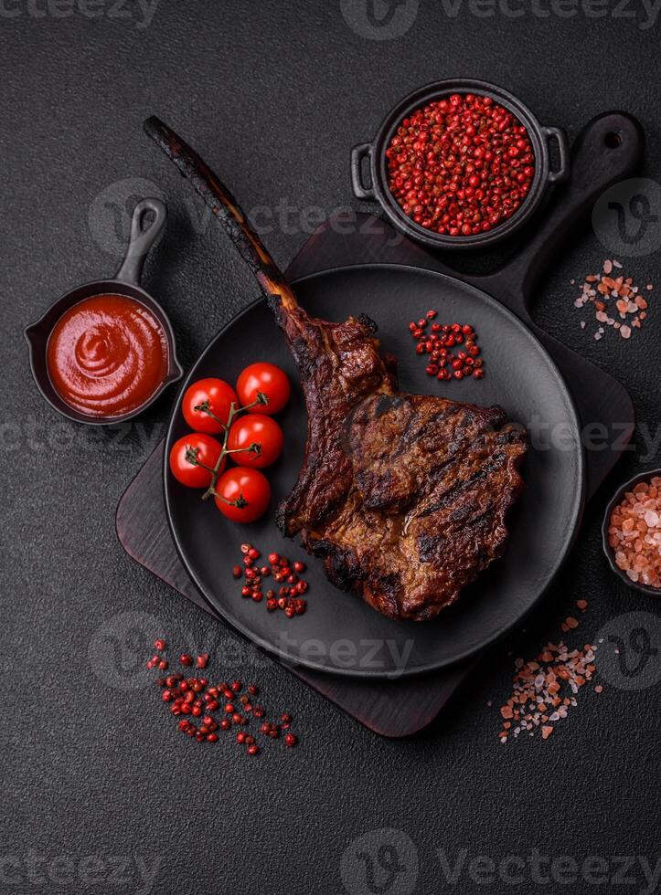 Grilled wagyu beef tomahawk steak with salt, spices and herbs photo